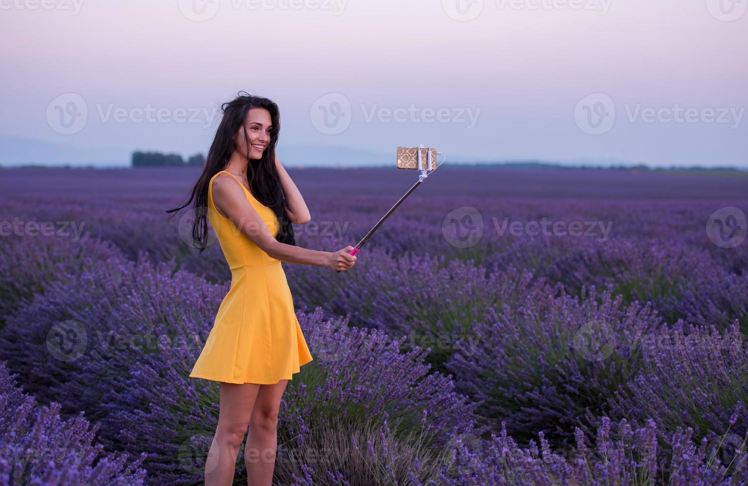couple in lavender field using smartphone photo