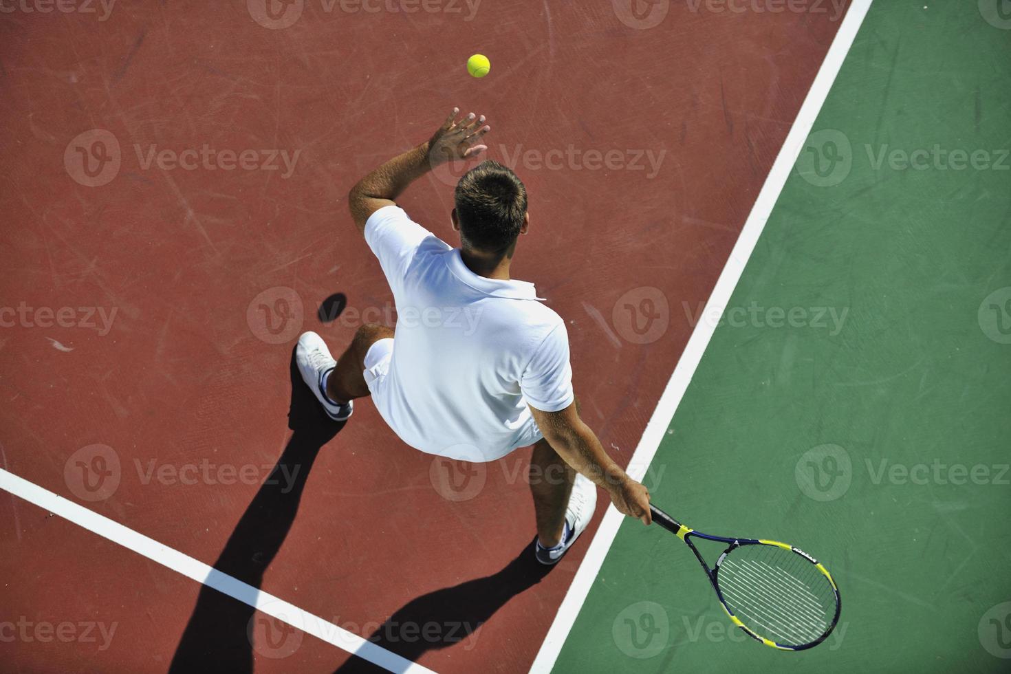 young man play tennis outdoor photo