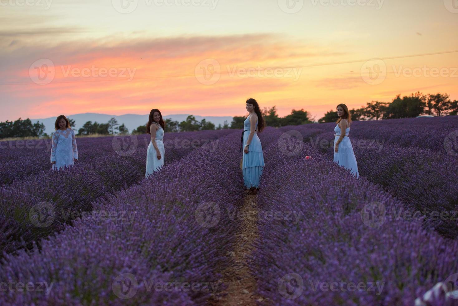 group of famales have fun in lavender flower field photo