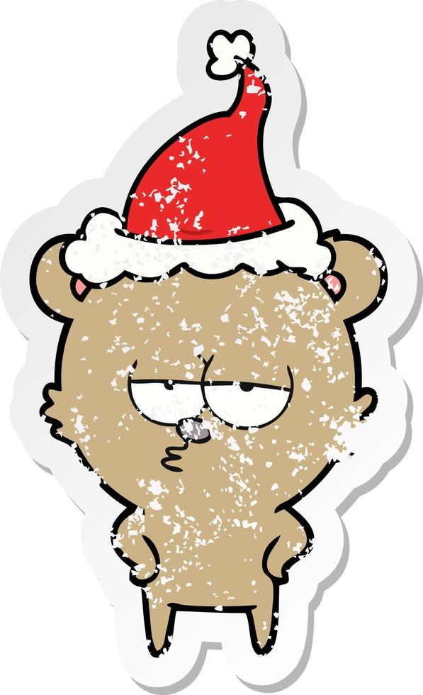 bored bear distressed sticker cartoon of a wearing santa hat vector