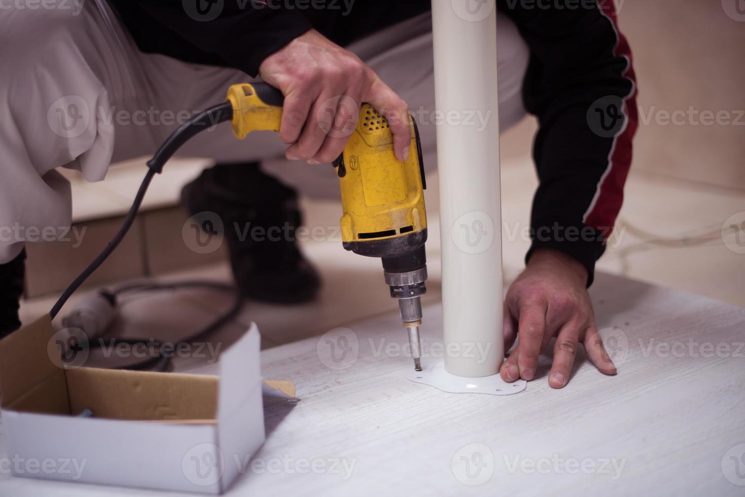 repairman working with drilling machine photo