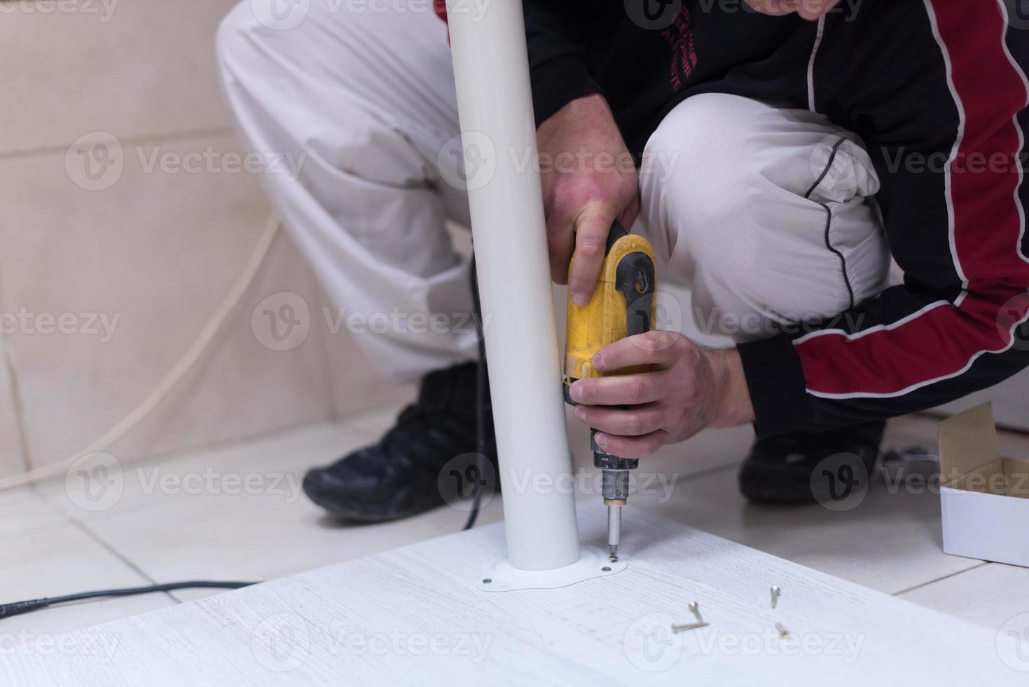repairman working with drilling machine photo