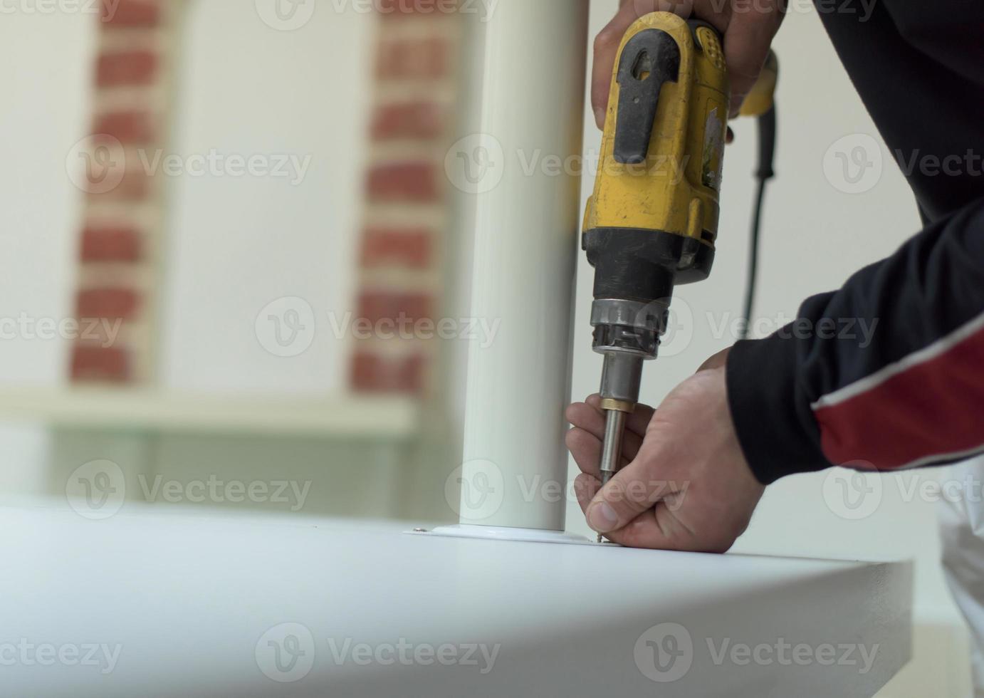 repairman working with drilling machine photo