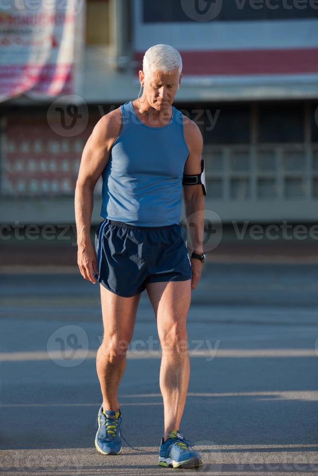 portrait of handsome senior jogging man photo