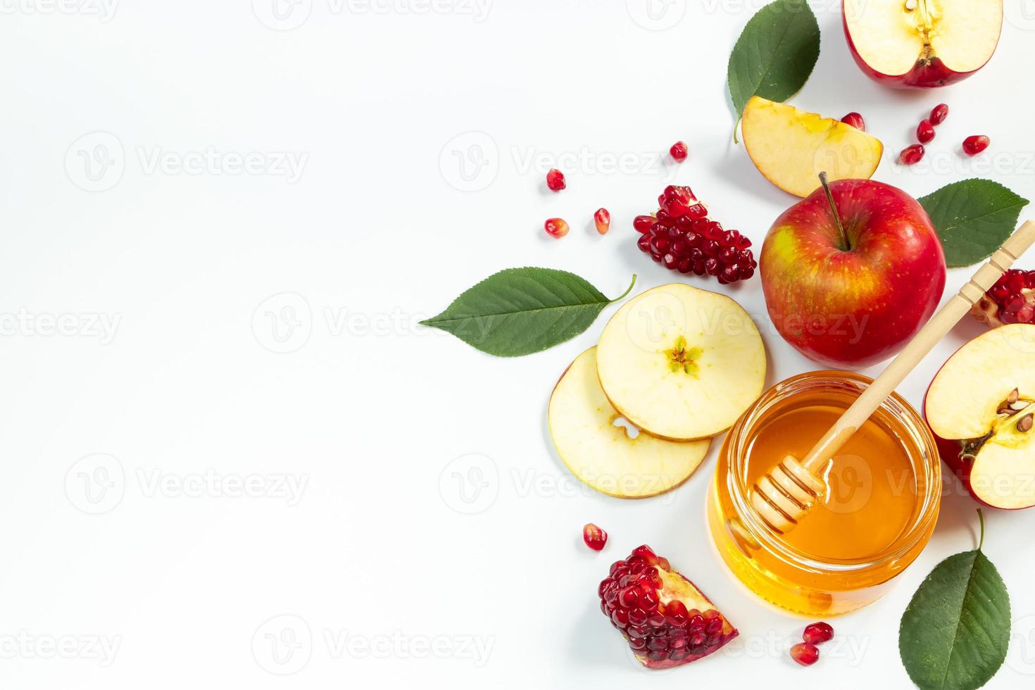 Concept of traditional Jewish holiday of Rosh Hashanah. New Year. Pomegranates, honey and apples on white background. Place for your text. photo