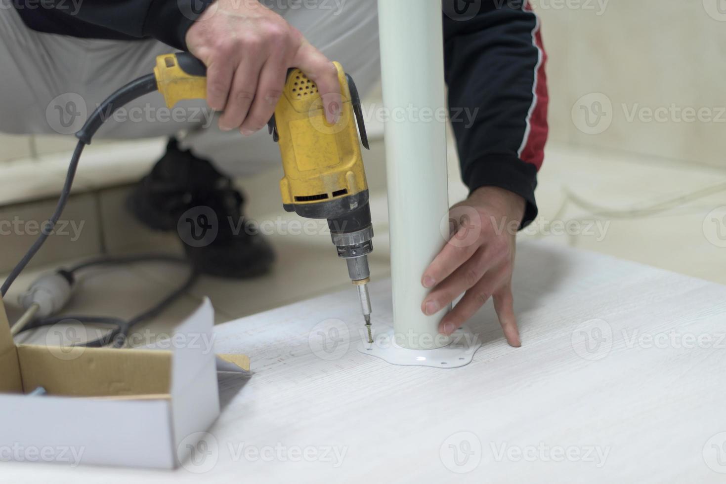 repairman working with drilling machine photo