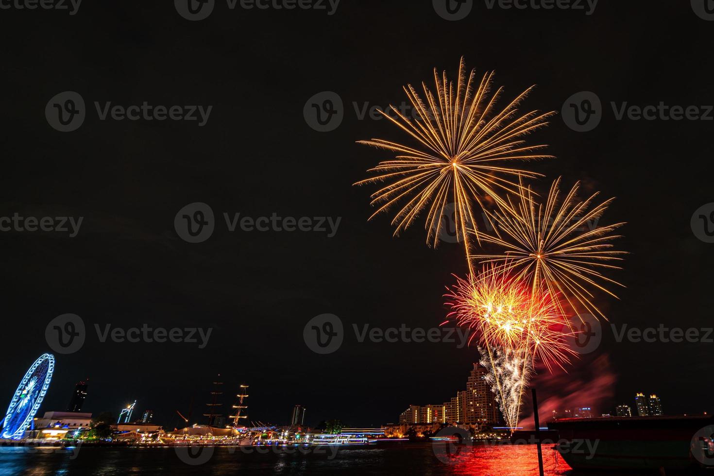 fireworks on the river in the dark sky photo