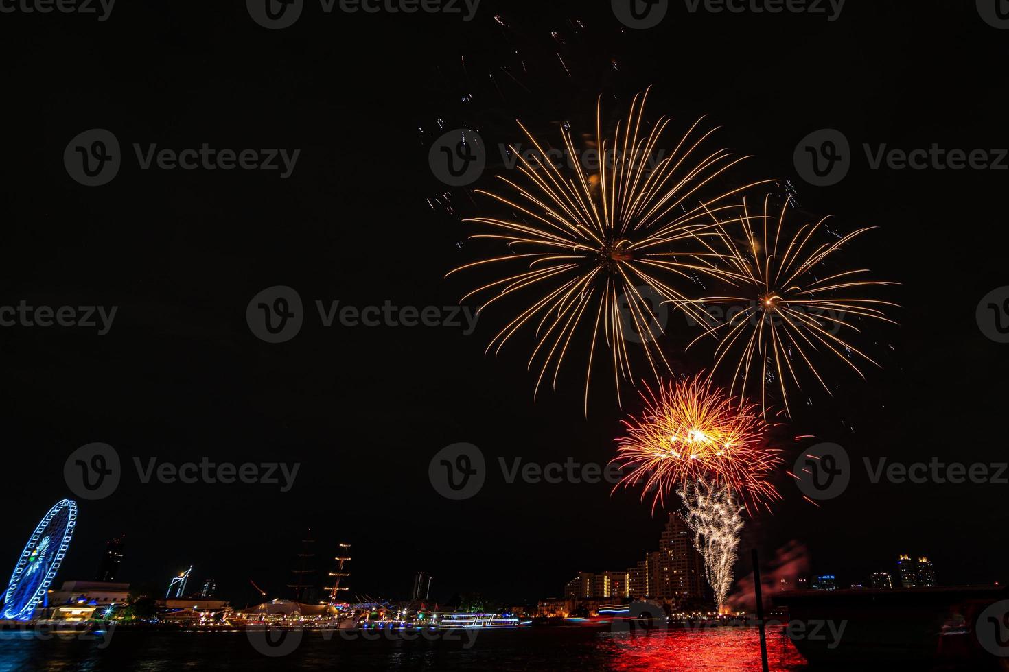 fireworks on the river in the dark sky photo