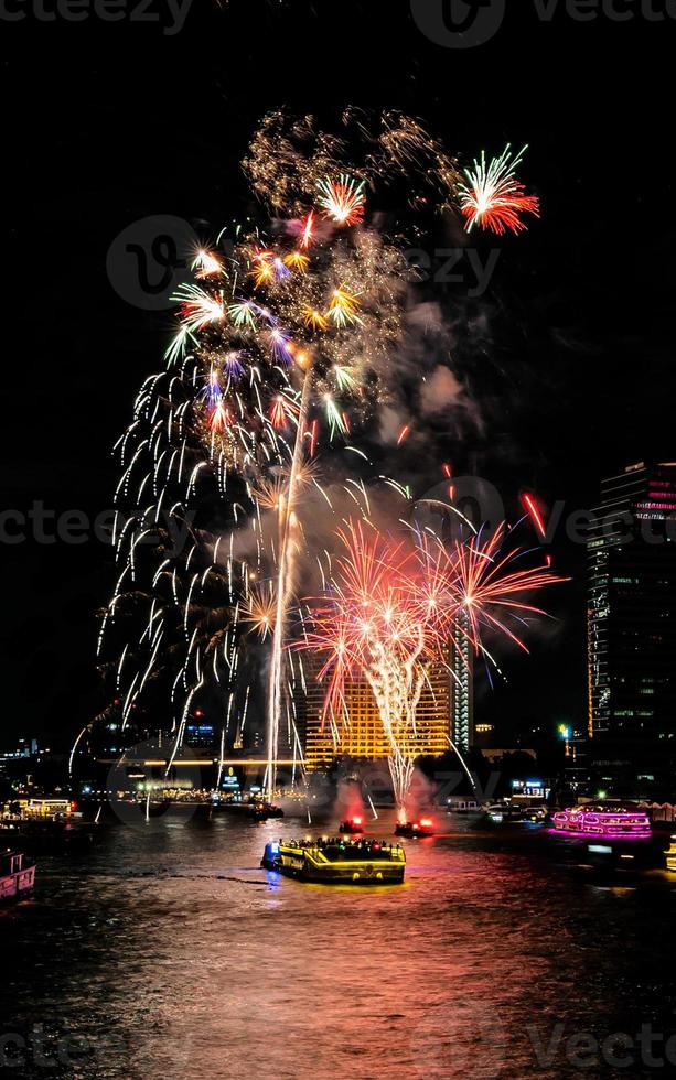 fireworks on the river in the dark sky photo