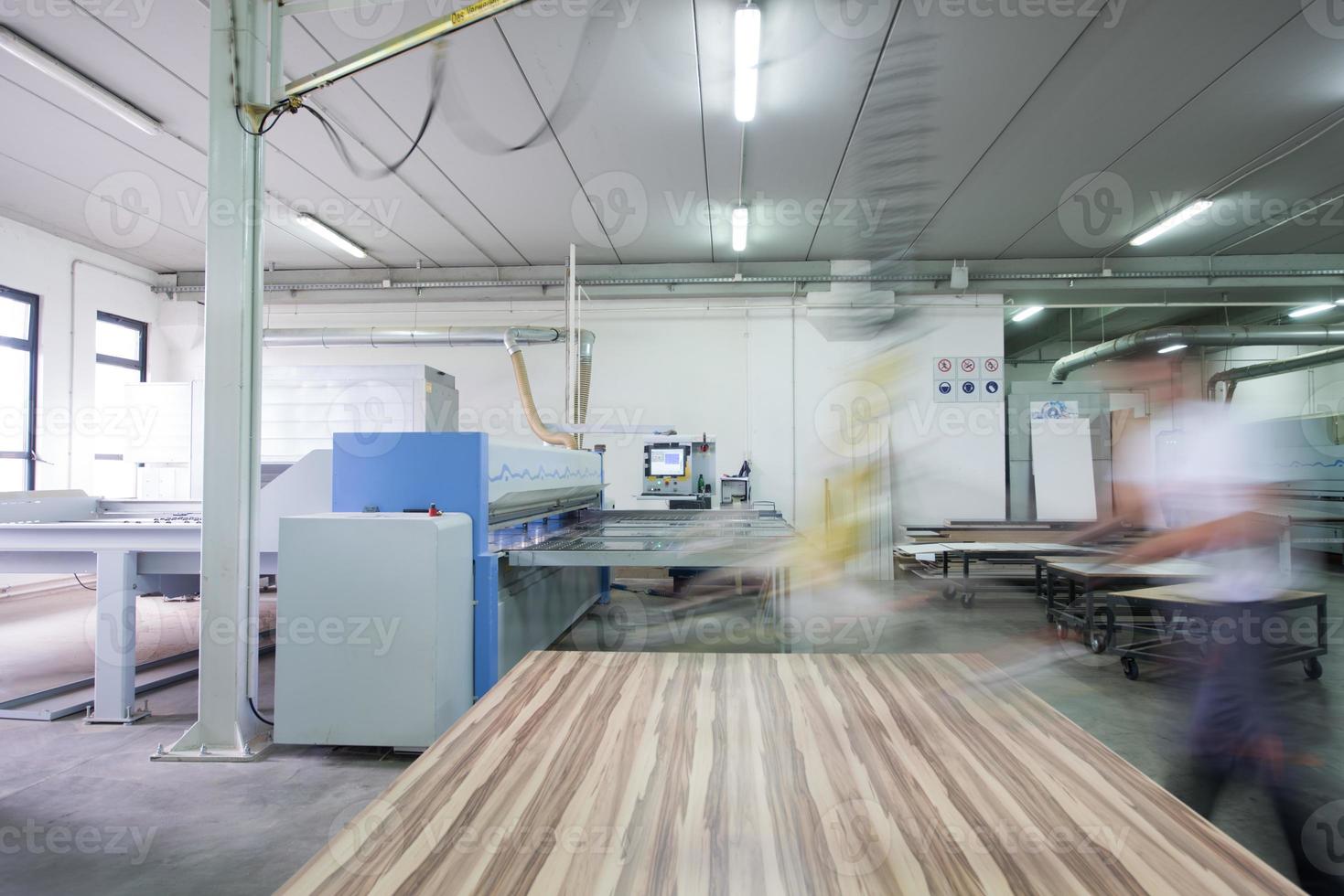 worker in a factory of wooden furniture photo