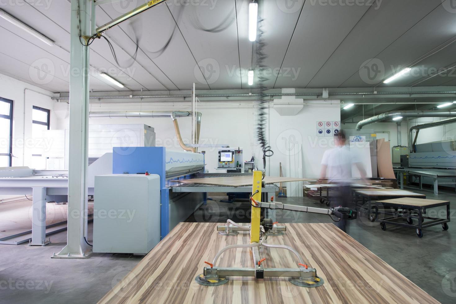 worker in a factory of wooden furniture photo