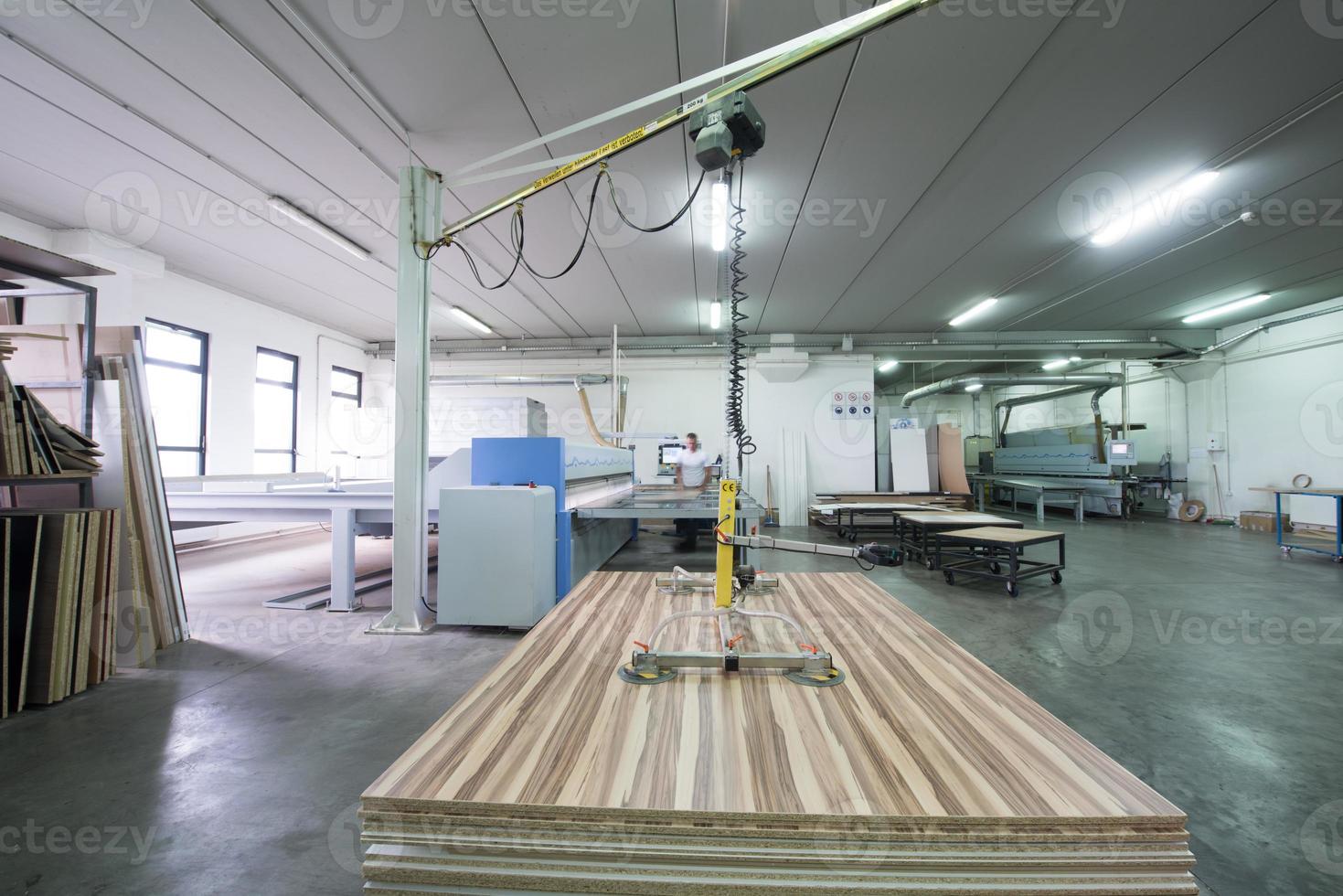 worker in a factory of wooden furniture photo