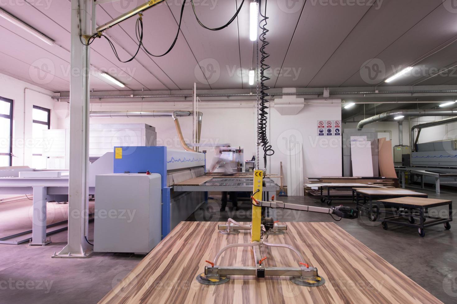 worker in a factory of wooden furniture photo