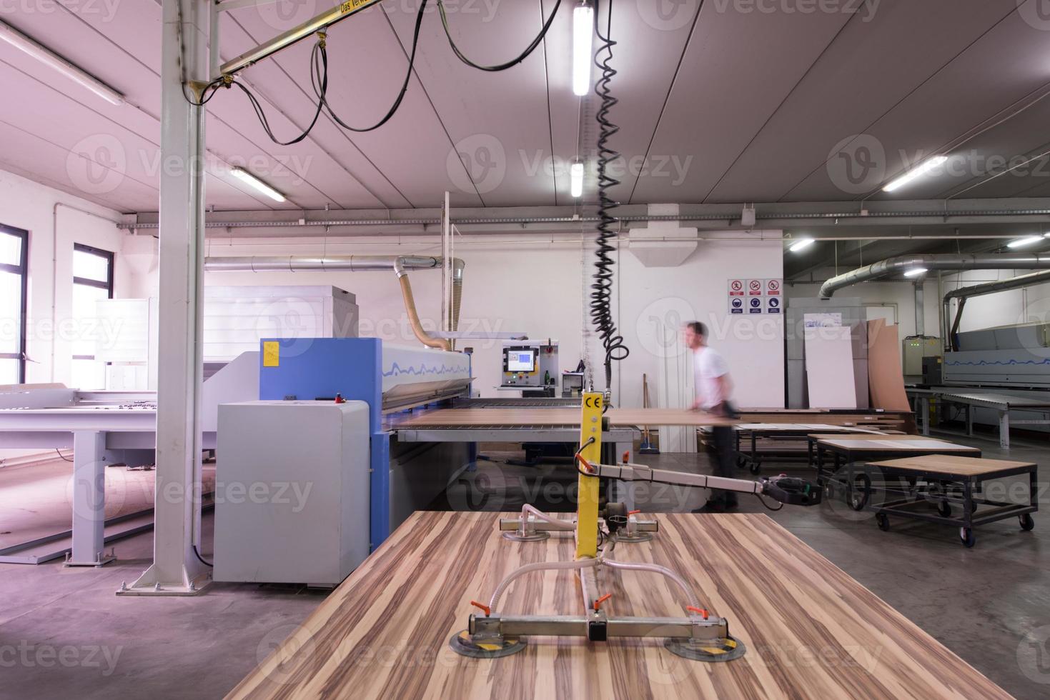 worker in a factory of wooden furniture photo