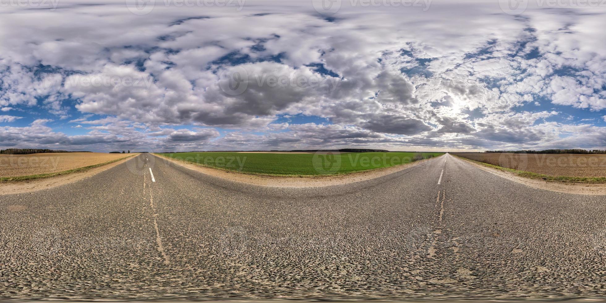 Full spherical seamless hdri panorama 360 degrees angle view on no traffic asphalt road among fields in evening with cloudy sky. 360 panorama in equirectangular projection, VR AR content photo
