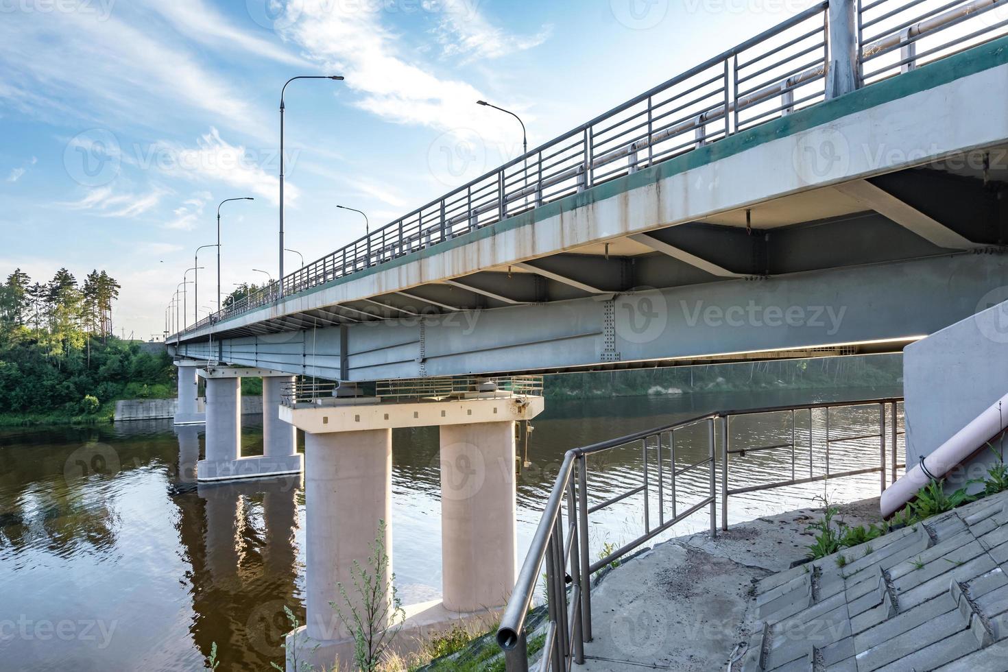 car bridge across the wide river photo