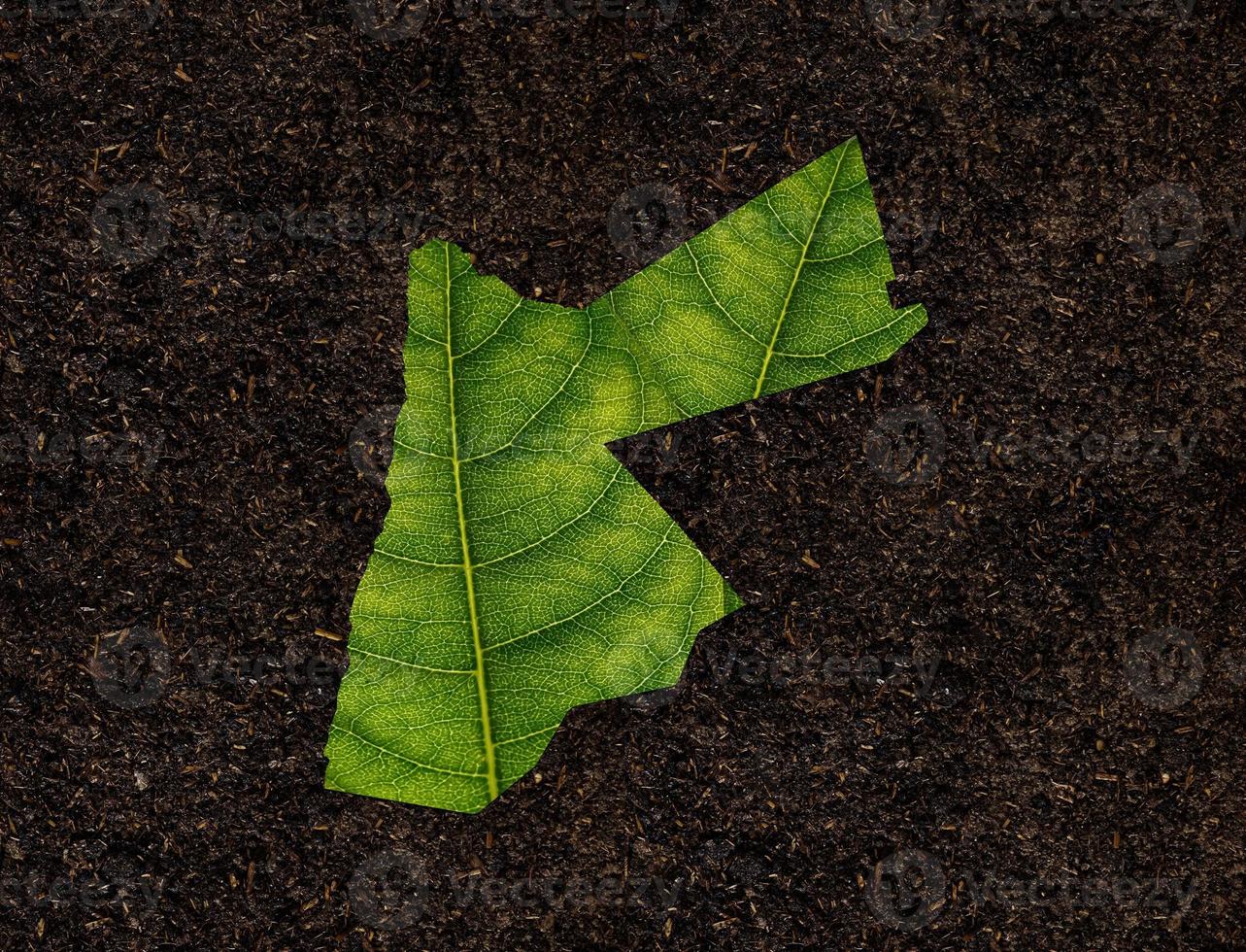 Jordan map made of green leaves on soil background ecology concept photo