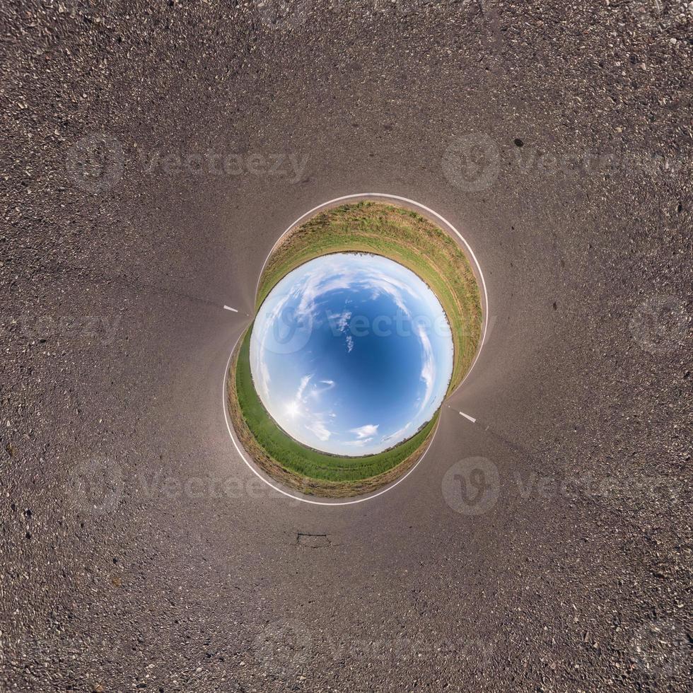 Inversion of little planet transformation of spherical panorama 360 degrees. Spherical abstract aerial view in field with awesome beautiful clouds. Curvature of space. photo