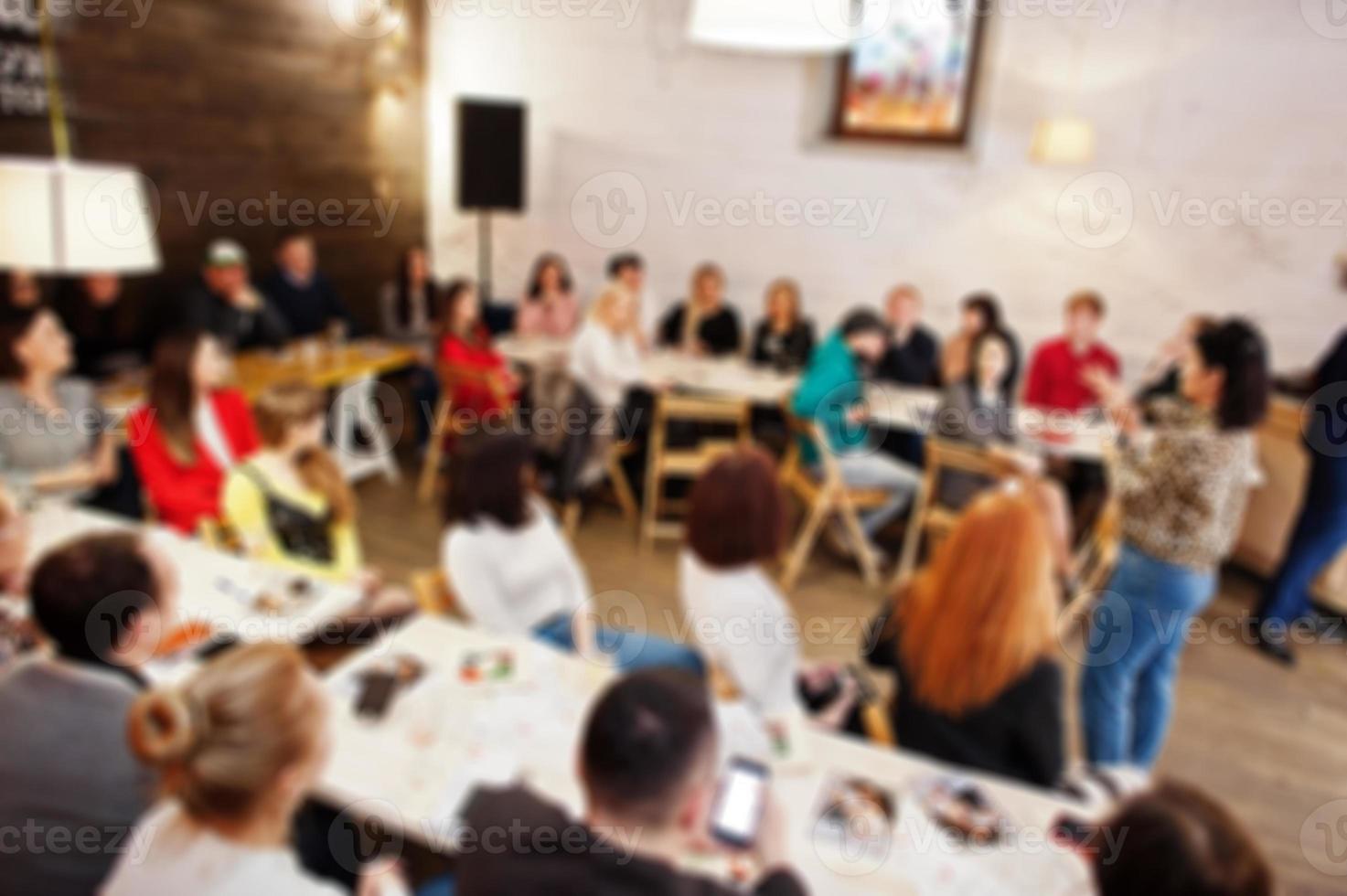Master class and study concept. Abstract blurred photo of conference or seminar room with speaker on the stage.