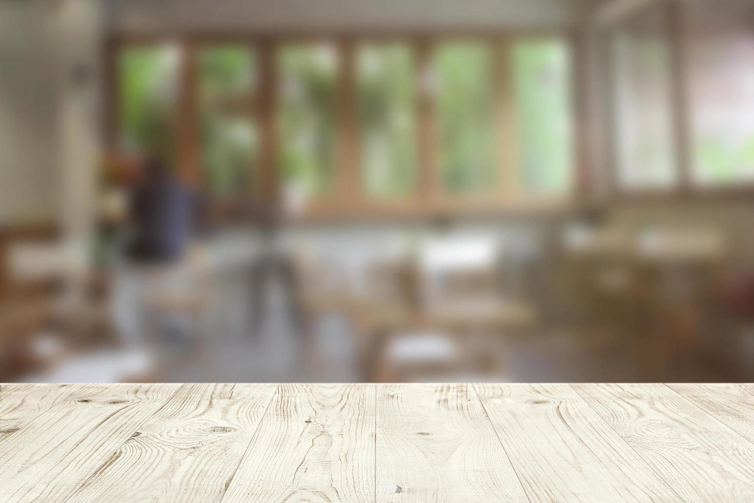 Empty wood table top on blur abstract of cafe or bar background, for montage product display photo