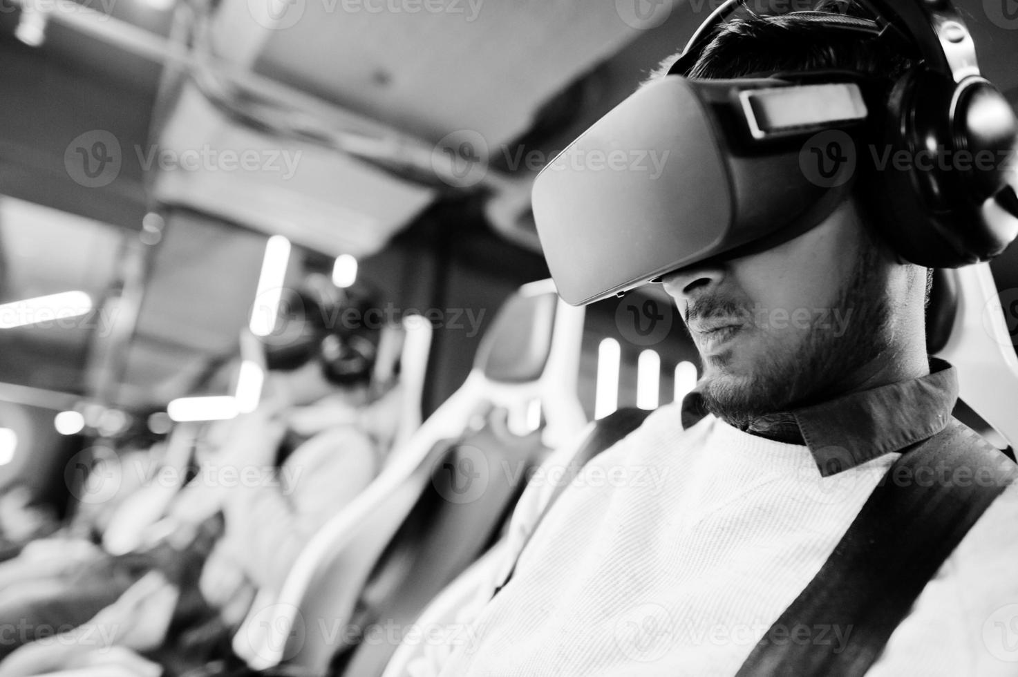 Two young indian people having fun with a new technology of a vr headset at virtual reality simulator. photo