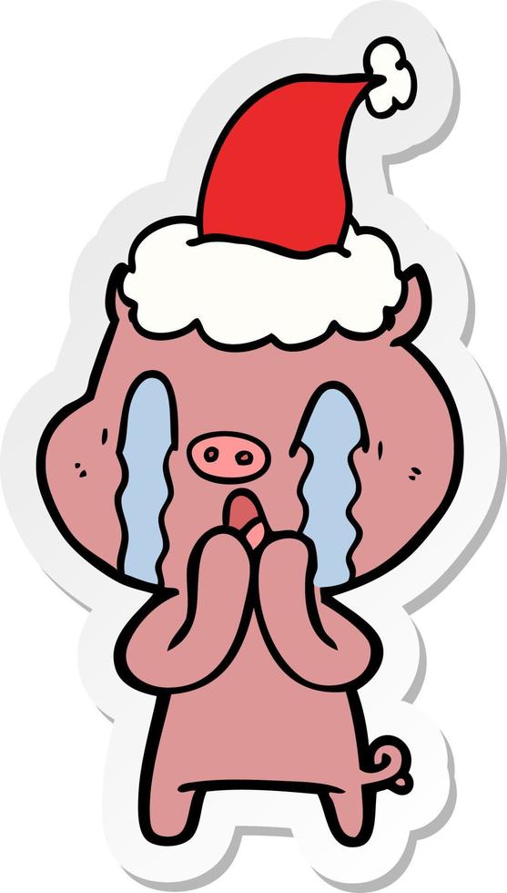 crying pig sticker cartoon of a wearing santa hat vector
