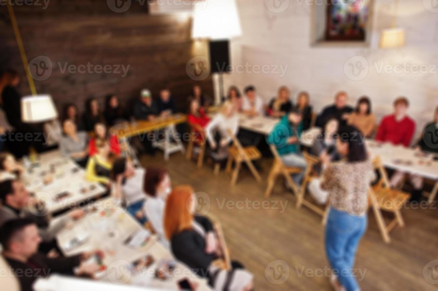Master class and study concept. Abstract blurred photo of conference or seminar room with speaker on the stage.