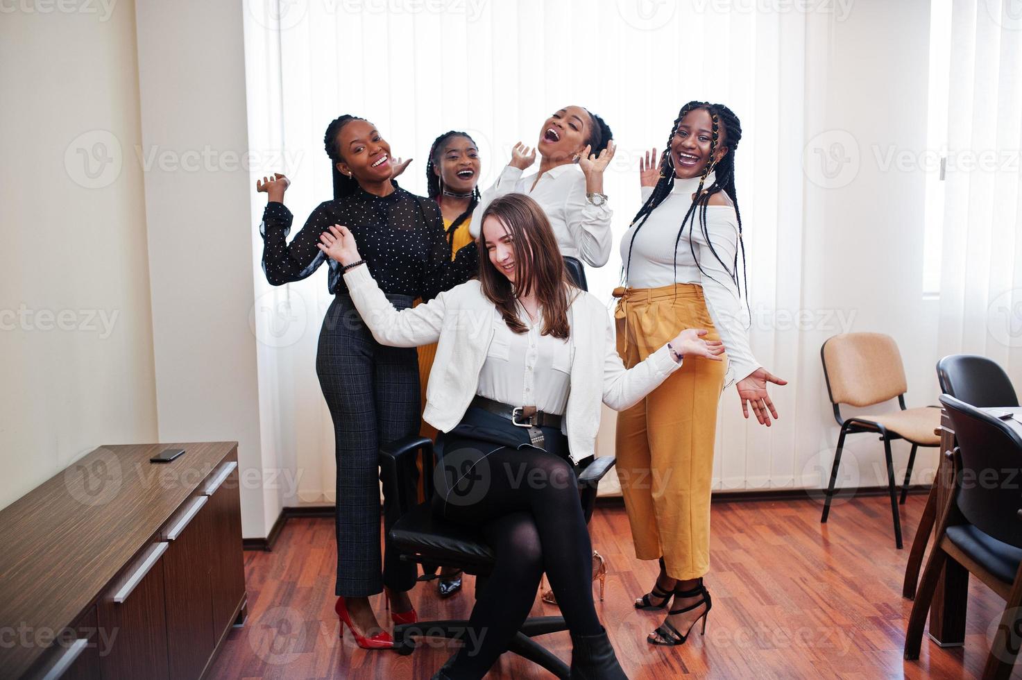 Five Multiracial Business Womans Standing At Office And Roll Woman On Chair Diverse Group Of