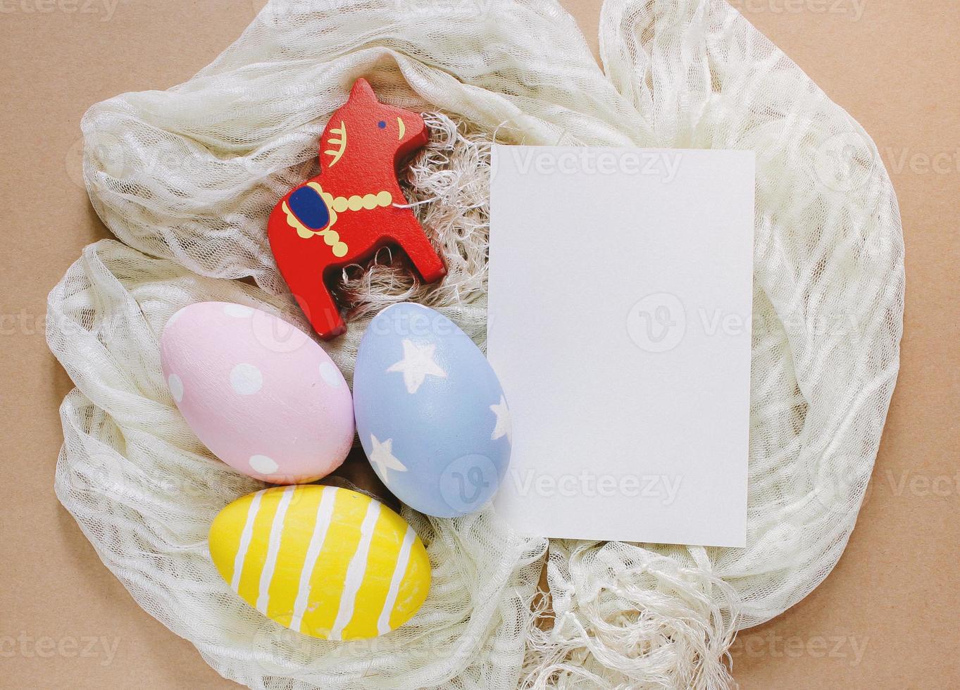 Colorful easter eggs with blank greeting card on cloth photo