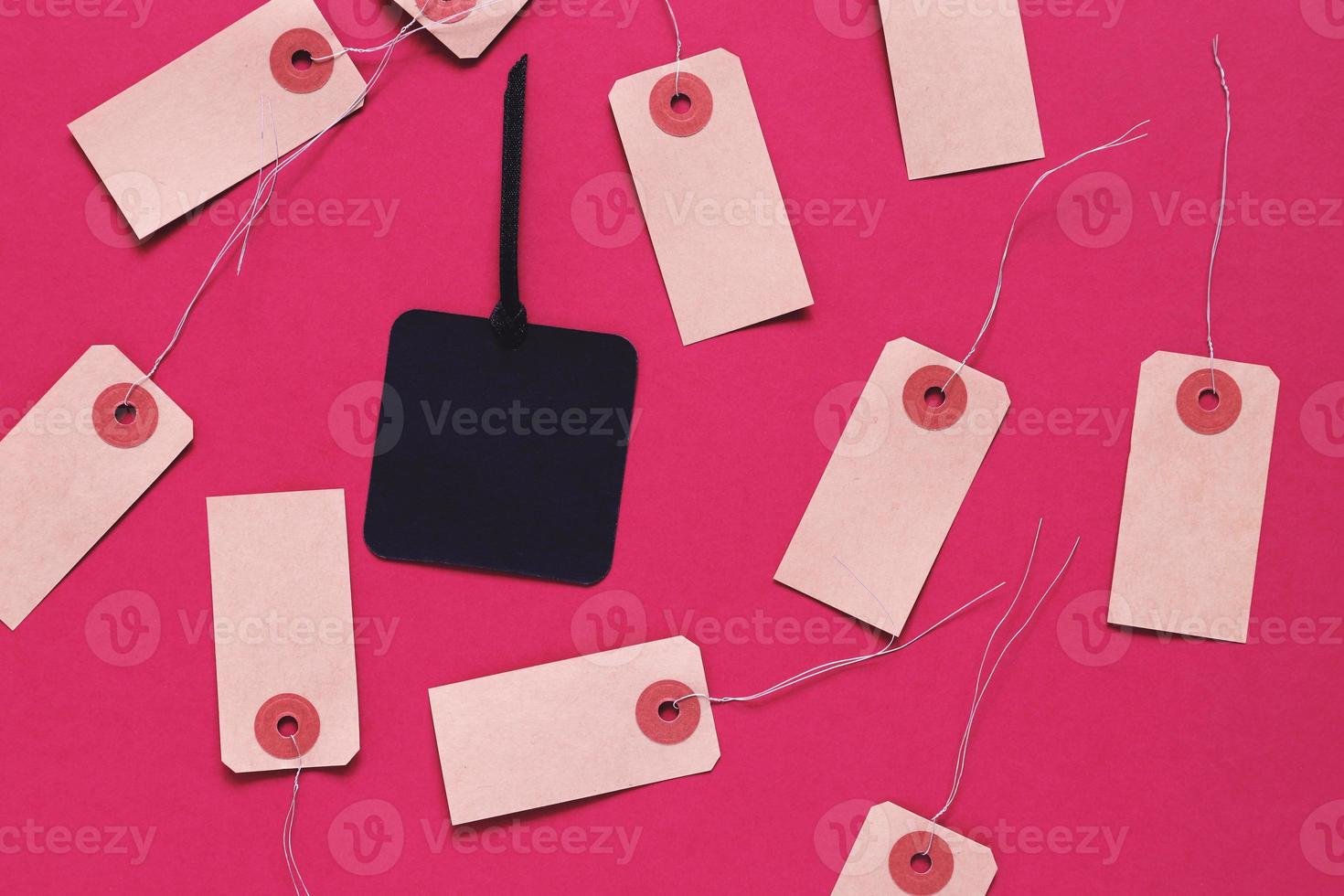 Black friday sale tag on black paper label surrounding with blank tag on red background, shopping concept photo