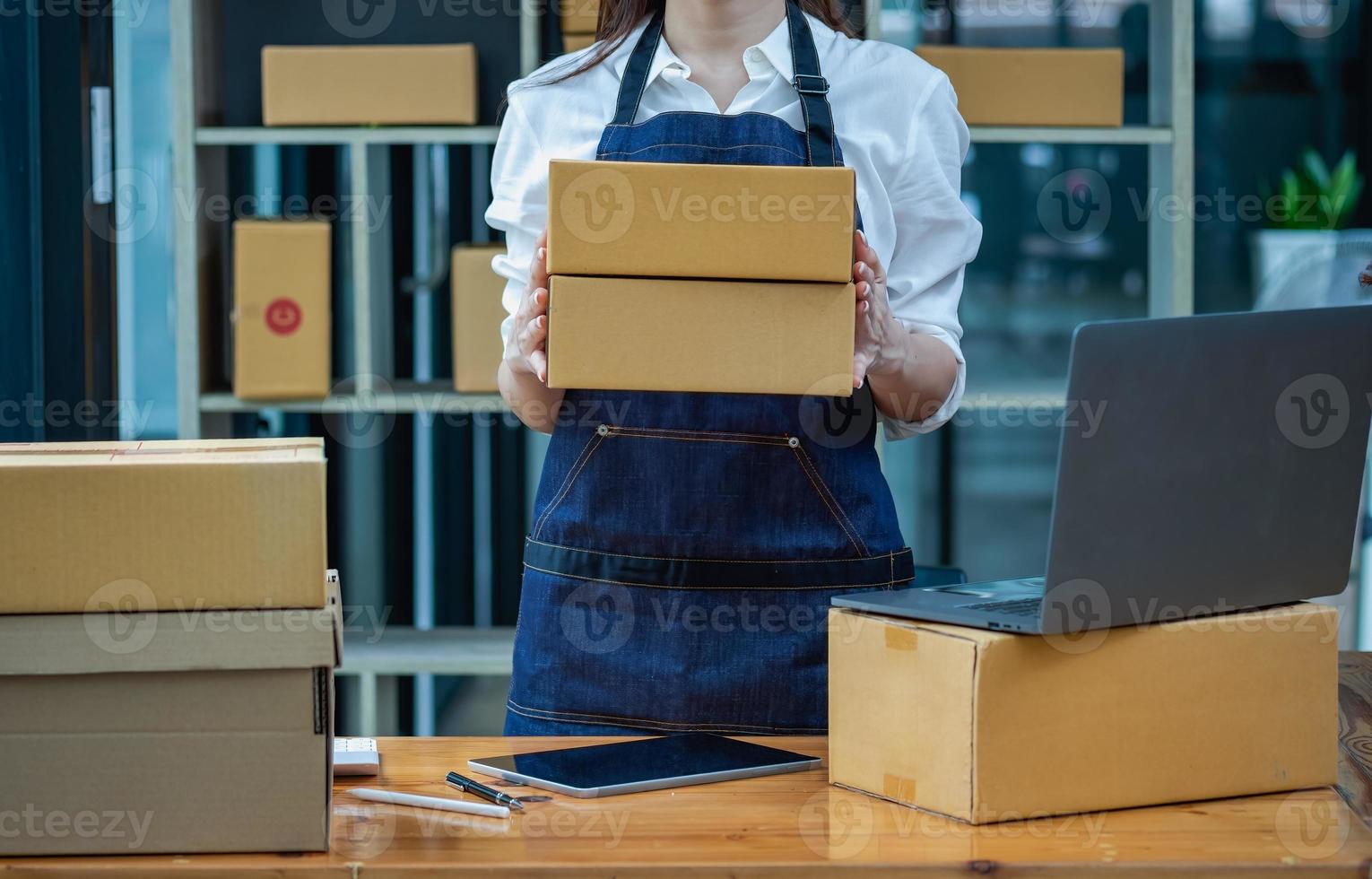 Businesswoman checking online for delivery to customers. photo