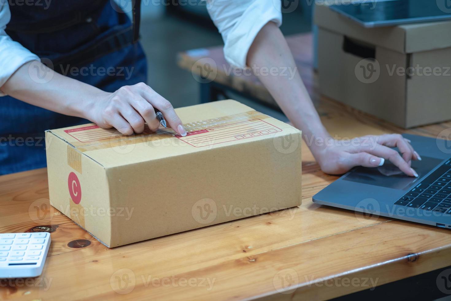 Online sales woman business owner Receive orders and deliver products with boxes to customers. Online SME business concept. photo
