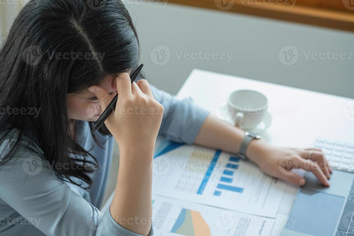 Concept Burnout Syndrome. Business Woman feels uncomfortable working. Which is caused by stress, accumulated from unsuccessful work And less resting body. Consult a specialist psychiatrist. photo
