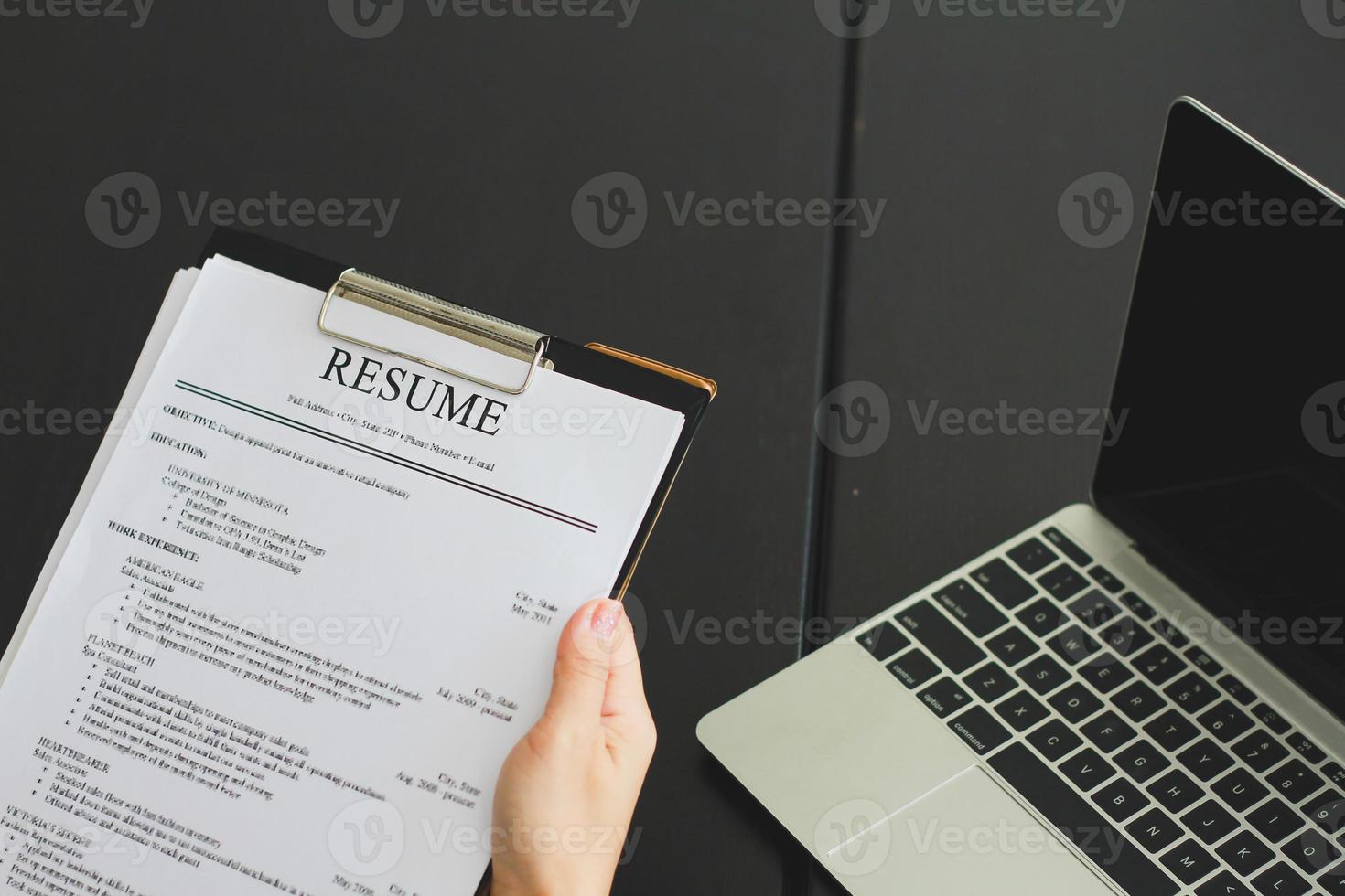 Close-up photo of a businesswoman holding resume