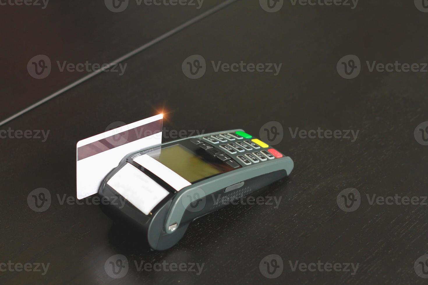 Credit card swipe machine for sell products in the shop. Concept of spending via credit card. photo