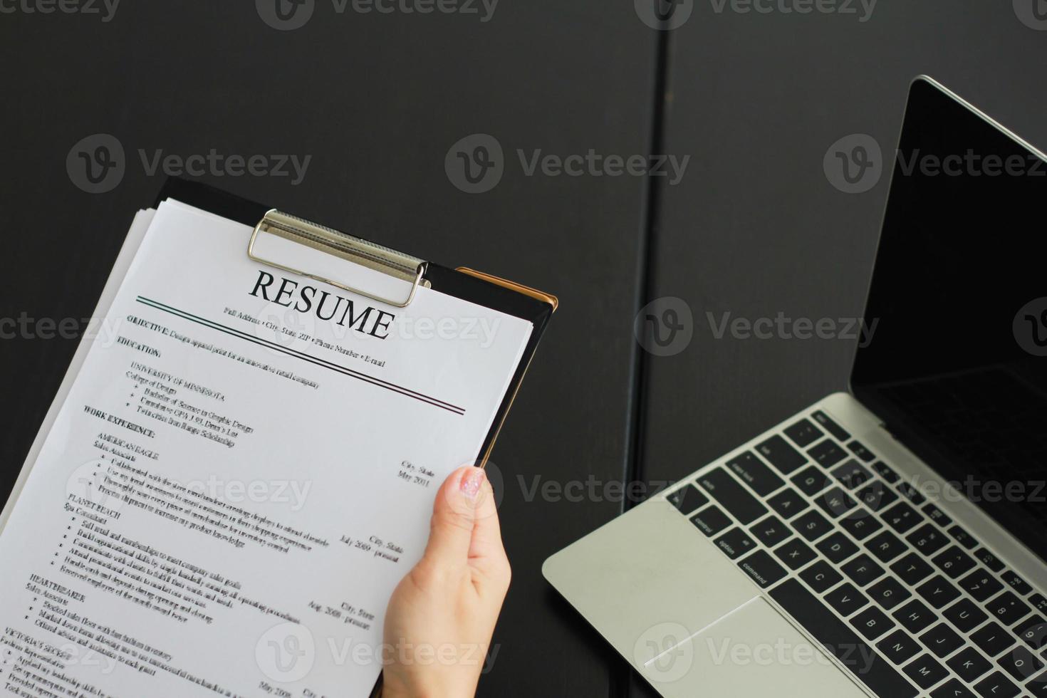 Close-up photo of a businesswoman holding resume