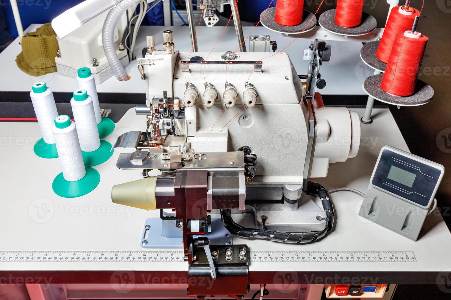 Overlocker and sewing machine as industrial equipment for light industry in a clothing factory. photo