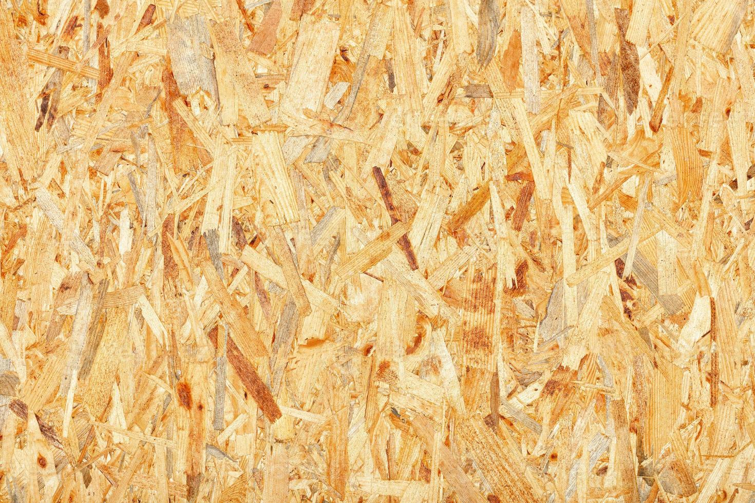 OSB, board texture and pressed sandy brown shavings background, close-up. photo
