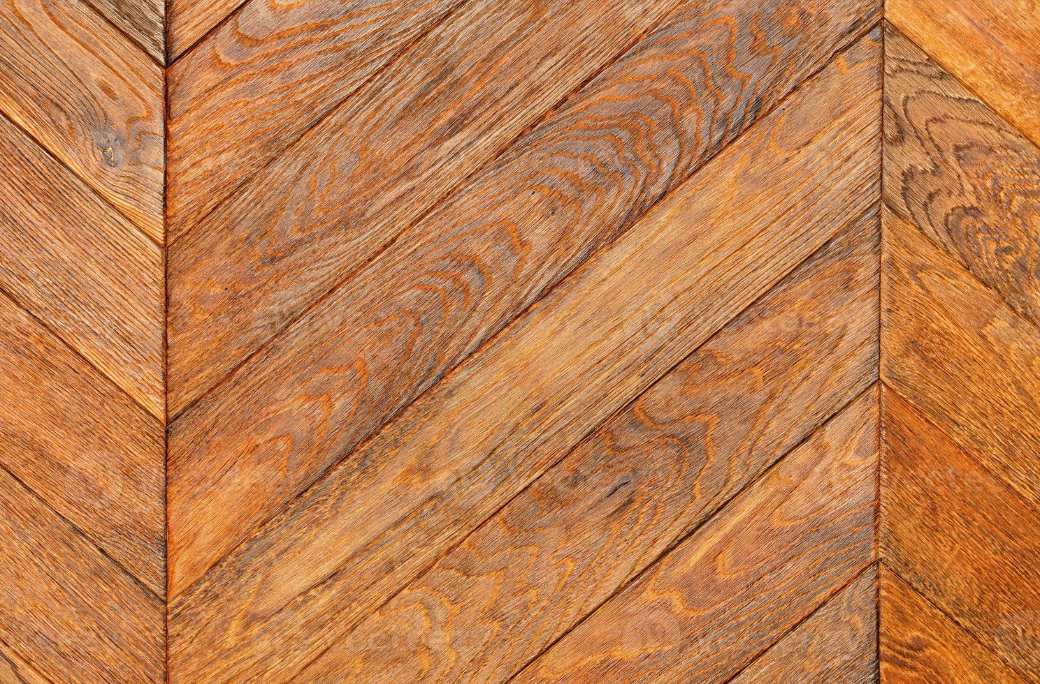 A beautiful texture of oak slats arranged diagonally in a herringbone pattern. photo