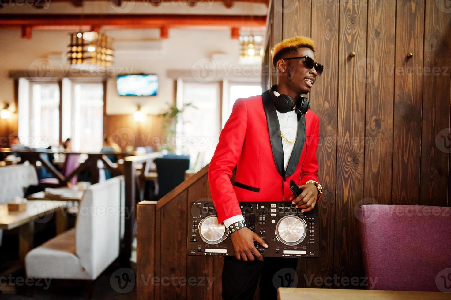 Fashion african american man model DJ at red suit with dj controller. photo
