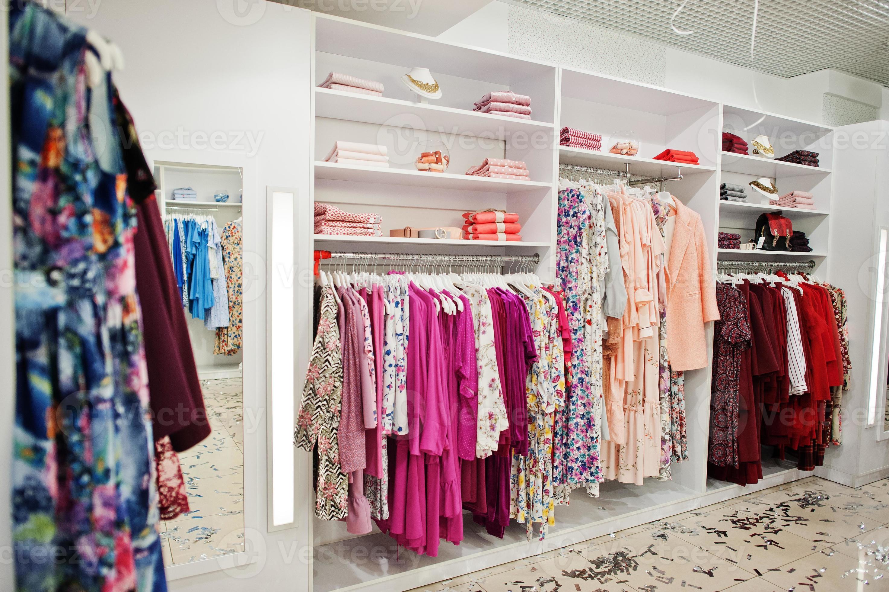 Female pink colorful clothing set of on the racks and shelves in clothing  store brand new modern boutique. Spring summer dress collections. 10380413  Stock Photo at Vecteezy