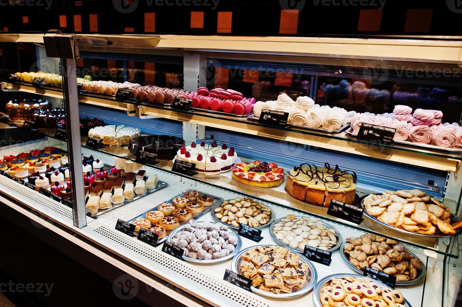 Various cakes on supermarket shelves for sale. photo