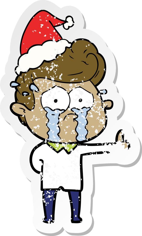 distressed sticker cartoon of a crying man wearing santa hat vector