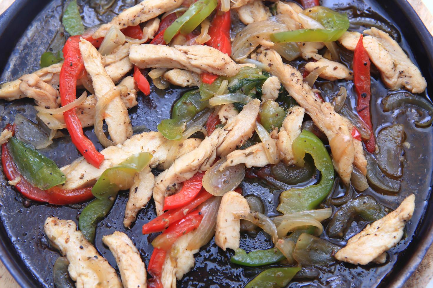 Hot skillet of chicken fajitas and vegetables photo