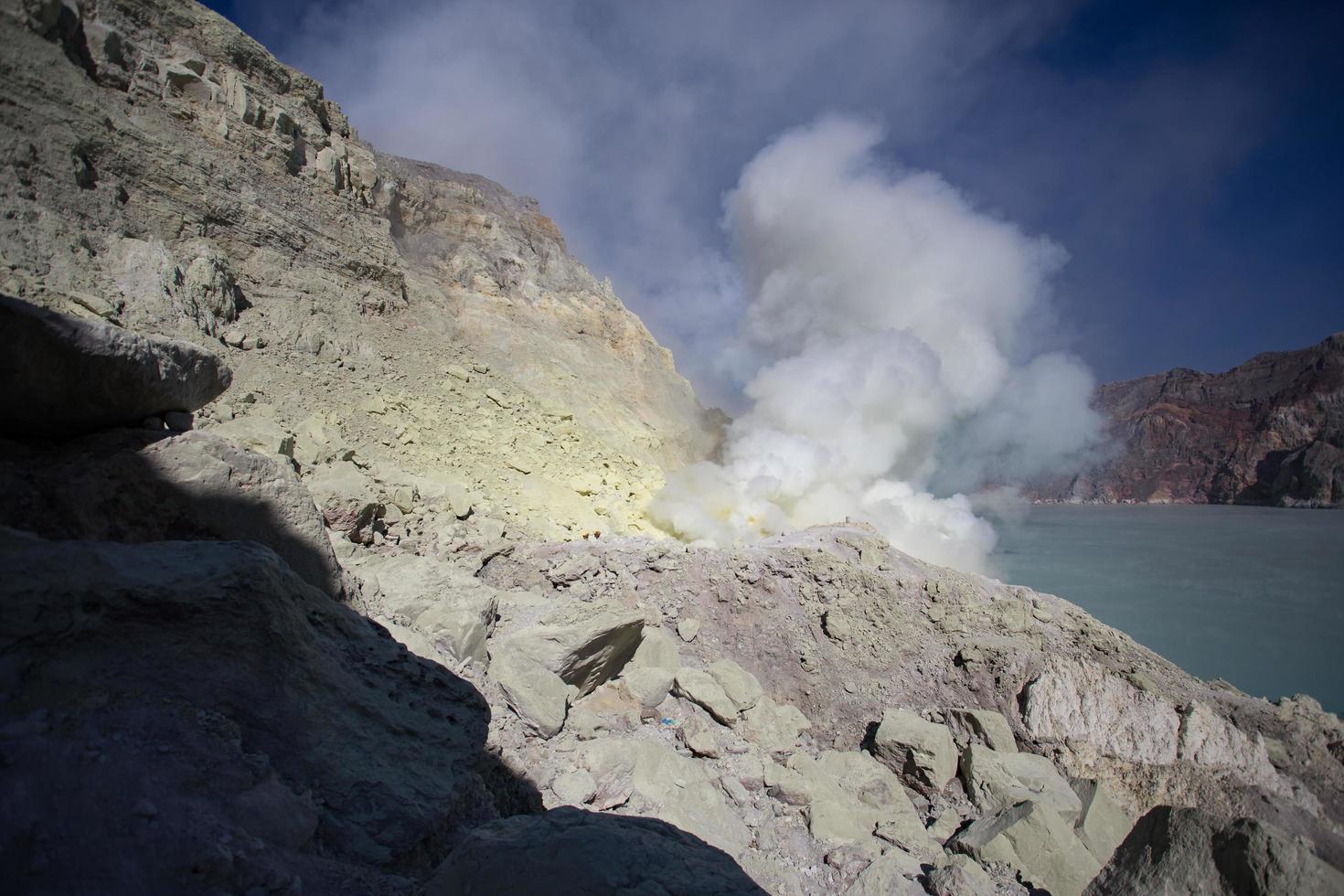 Sulfur mine with workers in Kawah Ijen, Java, Indonesia photo