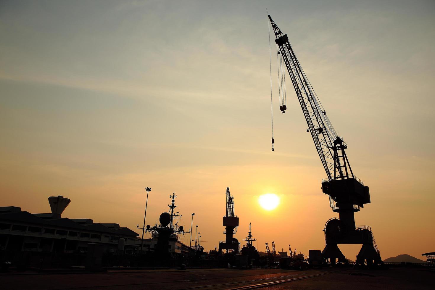 Cranes in dockside at sunset photo