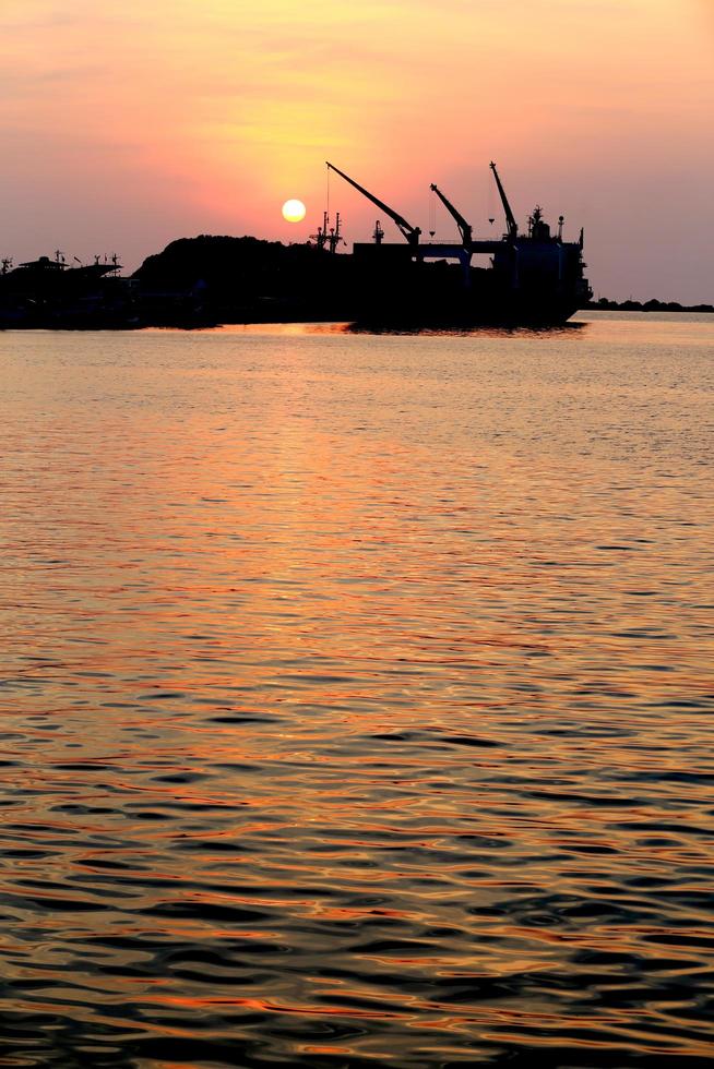 Cargo ship in the harbor at sunset photo