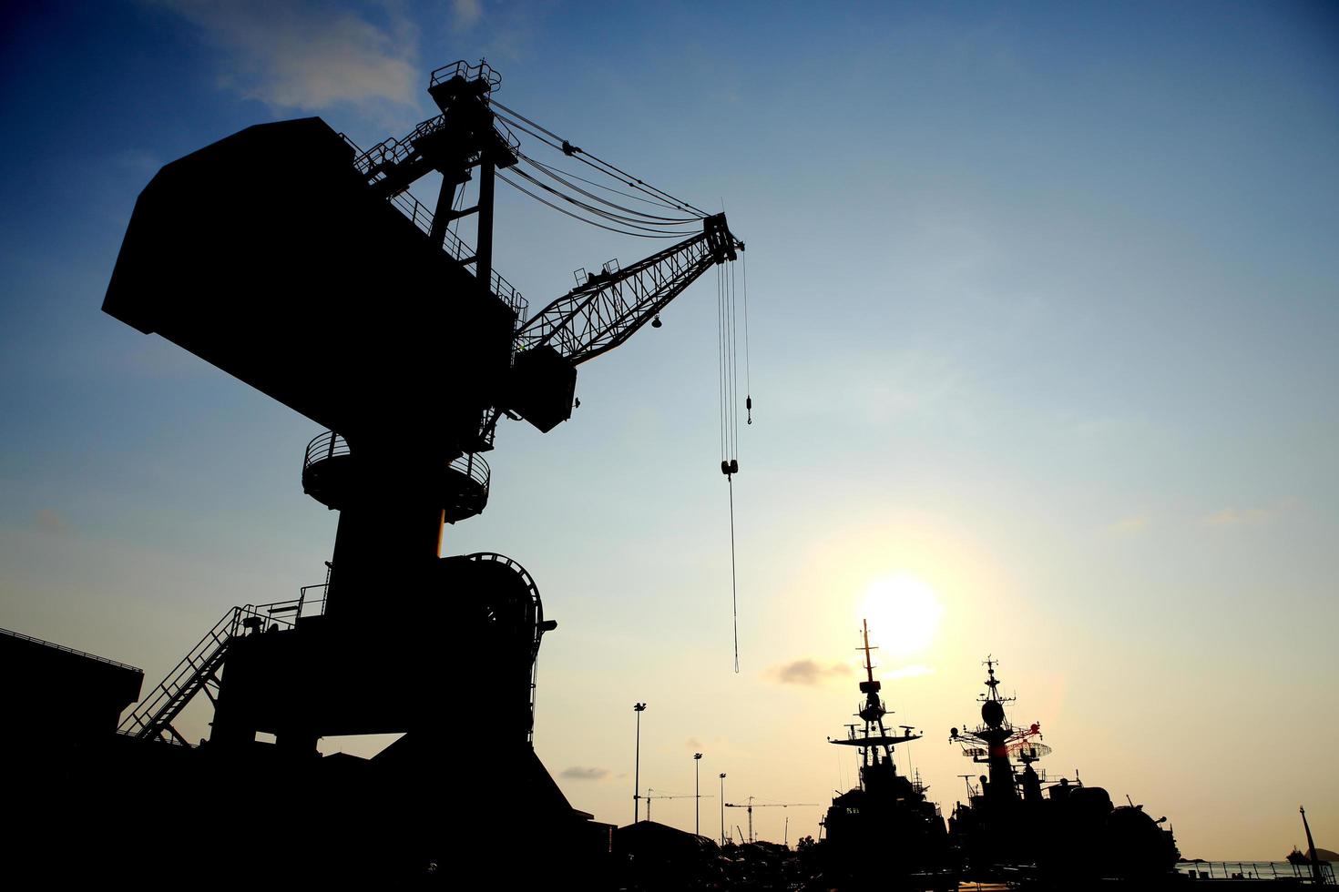 Cranes in dockside at sunset photo