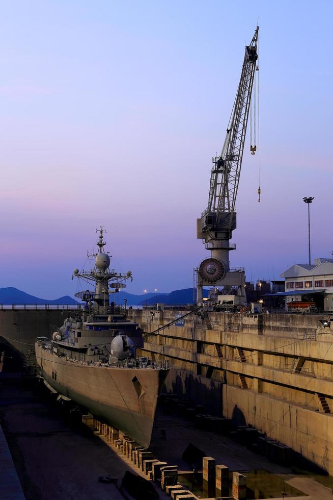 Crane near a covered dry dock at the shipyard photo