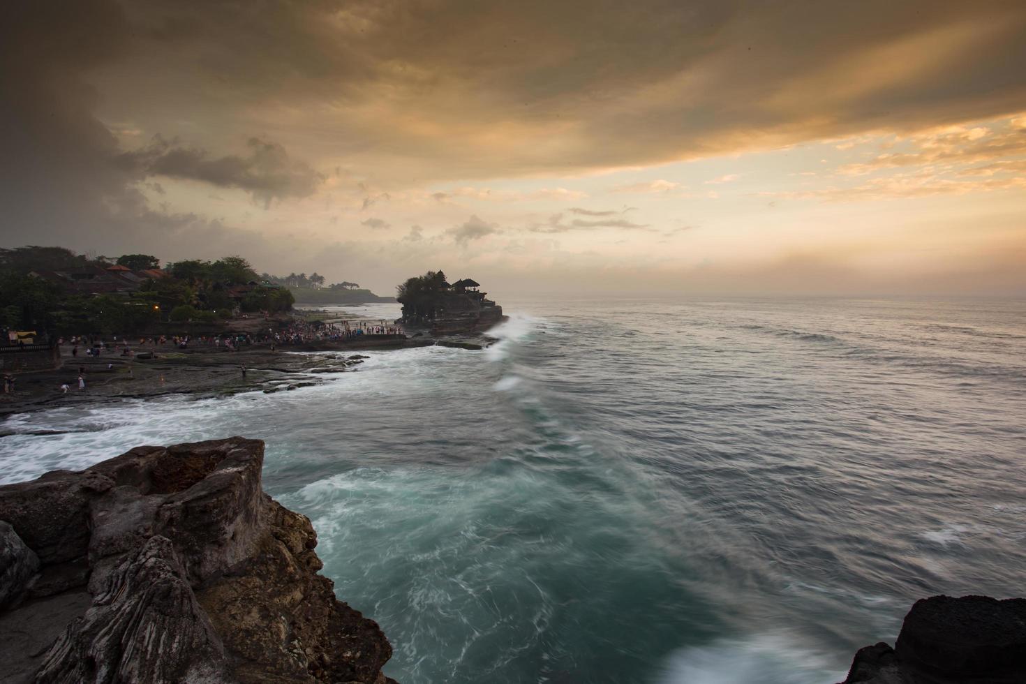 Tanah Lot Temple is a Hindu Temple set on the big rock photo